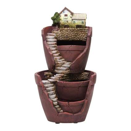 stacked broken terracotta pots with fairy house and stairs
