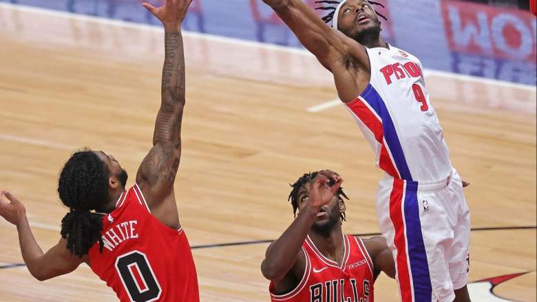 Coby White and Patrick Williams of the Chicago Bulls contesting Jerami Grant of the Detroit Pistons.