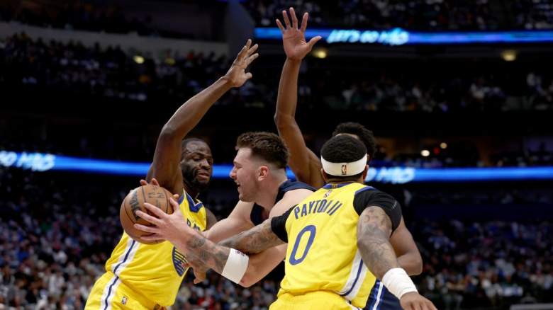 Mavs star Luka Doncic tries to score against Warriors star Draymond Green