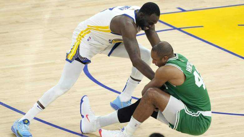 Draymond Green and Al Horford wrestle for a loose ball