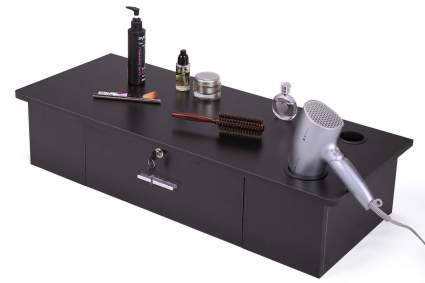 black wall mounted drawer holding hairstyling tools