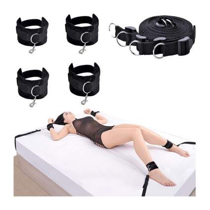 black cuffs and woman in bondage on a bed