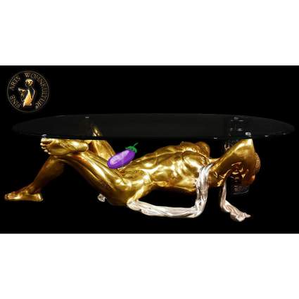 Coffee table with a base of a gold statue of a naked man
