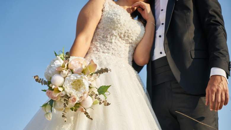 Bride with bouquet and groom