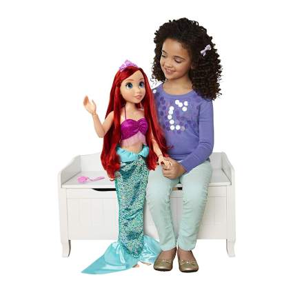 large Ariel mermaid toy with little girl
