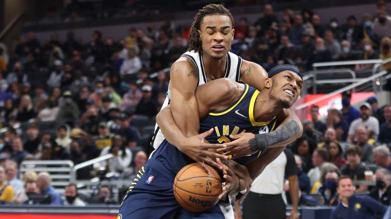 The Nets' Nic Claxton (top) grabs Myles Turner of the Pacers.