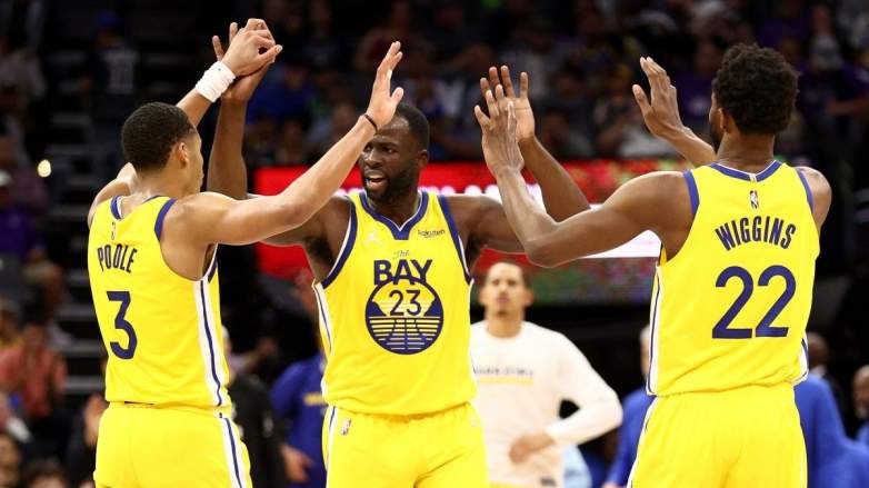 Jordan Poole, Draymond Green, and Andrew Wiggins of the Golden State Warriors.