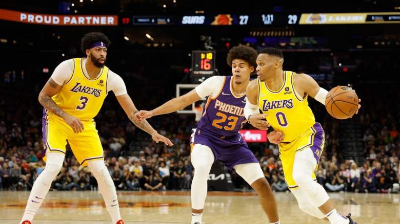 Lakers guard Russell Westbrook dribbles the ball while being guarded by Suns wing Cameron Johnson