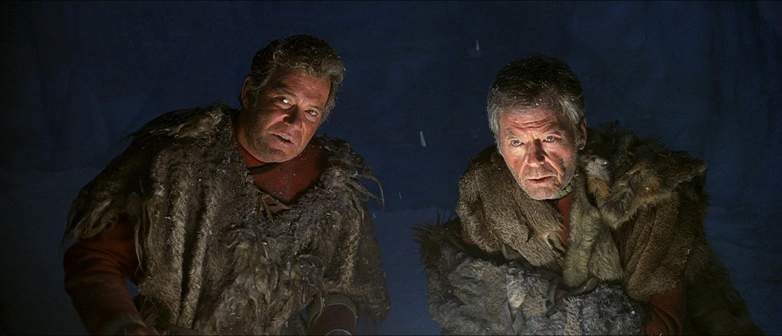 Kirk and McCoy wearing fur shawls on Rura Penthe