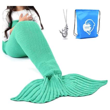 adult in teal mermaid tail blanket