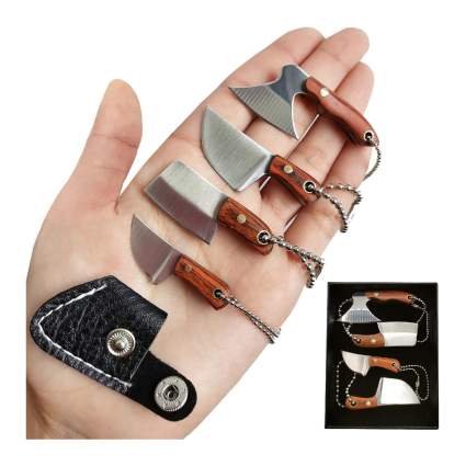 hand holding four miniature knives