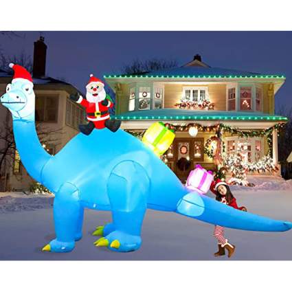 Large inflatable blue dinosaur with santa claus