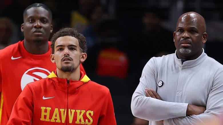 Trae Young (center) and coach Nate McMillan (right)
