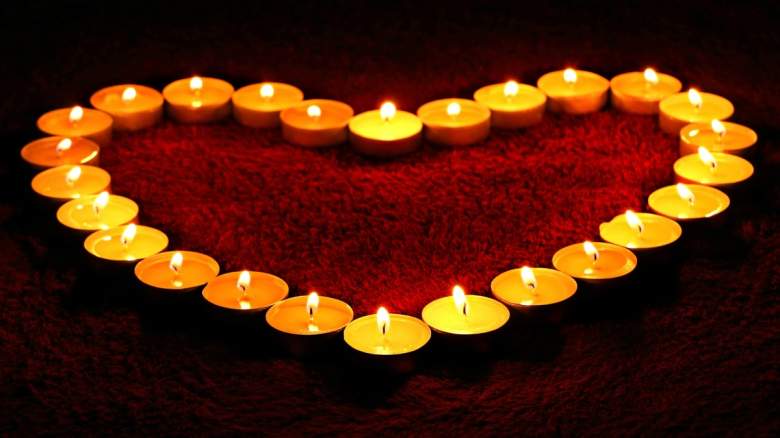 Lit tea candles in a heart