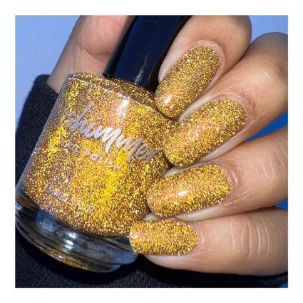 Gold glittery nail polish on nails