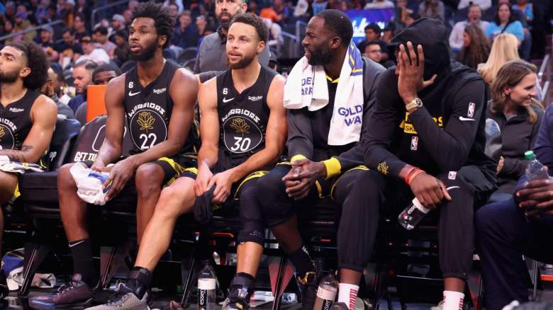 Andrew Wiggins, Stephen Curry, and Draymond Green on the Golden State Warriors Bench.