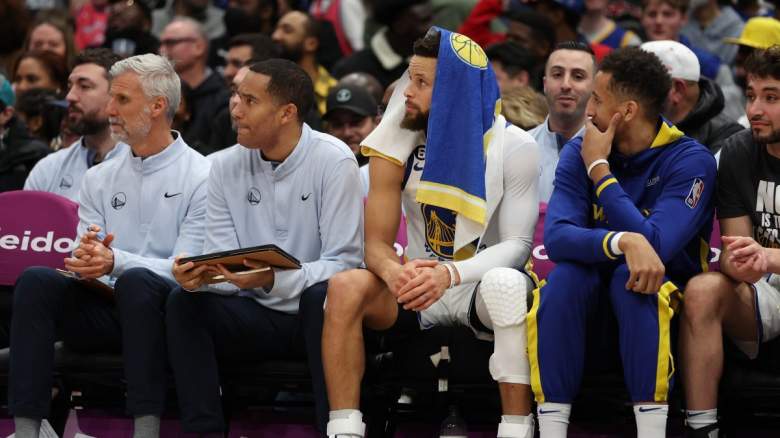 Stephen Curry sitting on the Golden State Warriors bench.