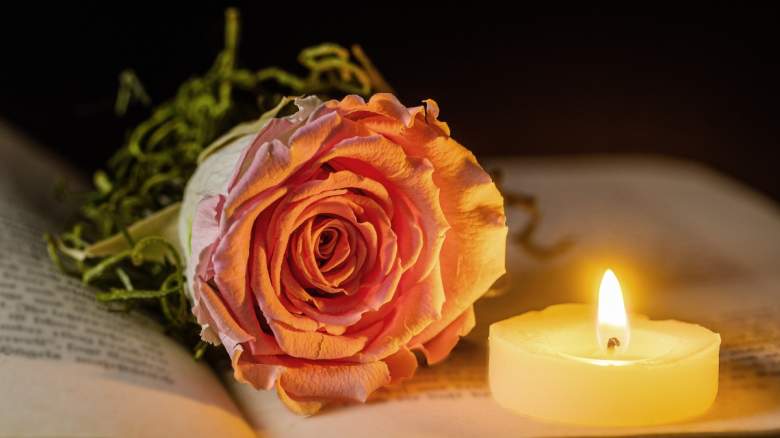 A rose and lit candle