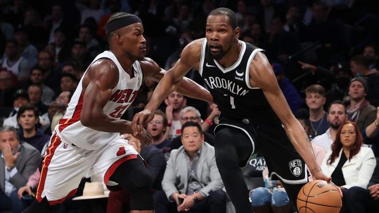 Kevin Durant of the Brooklyn Nets drives on Jimmy Butler of the Miami Heat.