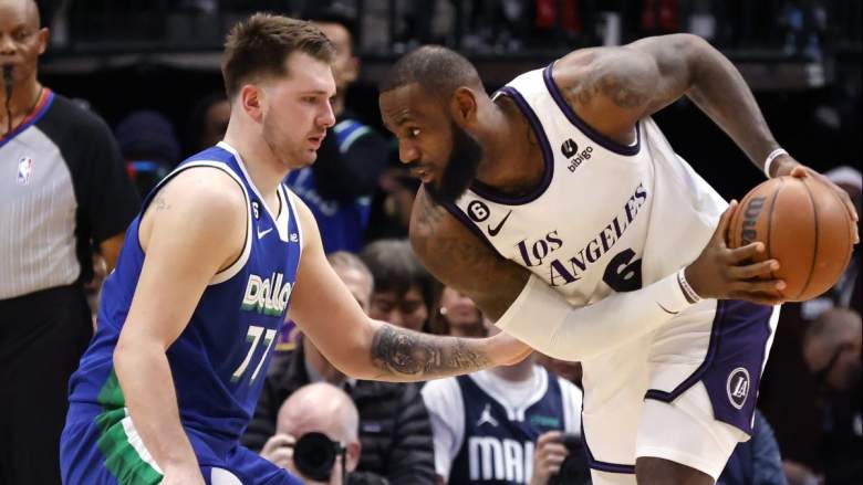 LeBron James of the Los Angeles Lakers is guarded by Luka Doncic of the Dallas Mavericks.