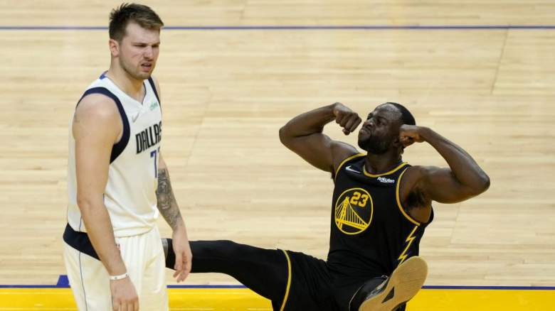 Draymond Green of the Golden State Warriors flexes on Luka Doncic of the Dallas Mavericks.