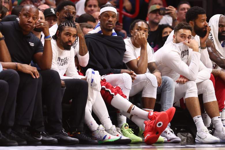 Jimmy Butler sits with his Miami Heat teammates on the bench.