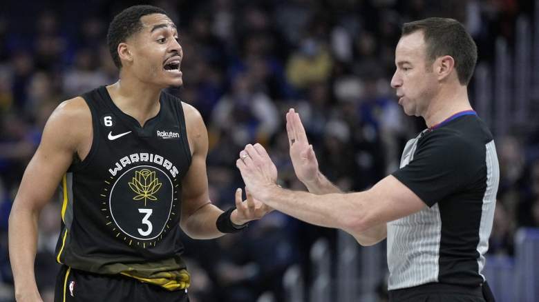 Jordan Poole of the Golden State Warriors argues with referee Josh Tiven.