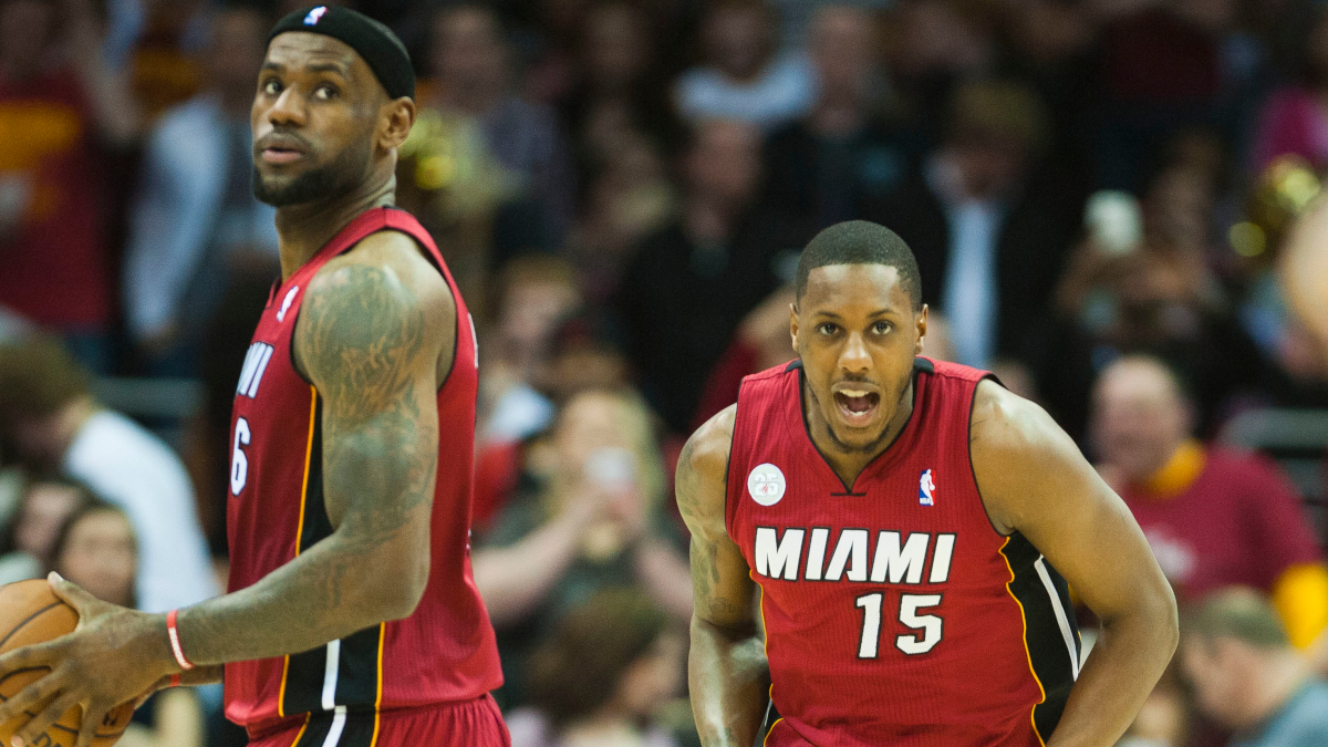 Miami Heat's Dwyane Wade, left, and Mario Chalmers, right, try to