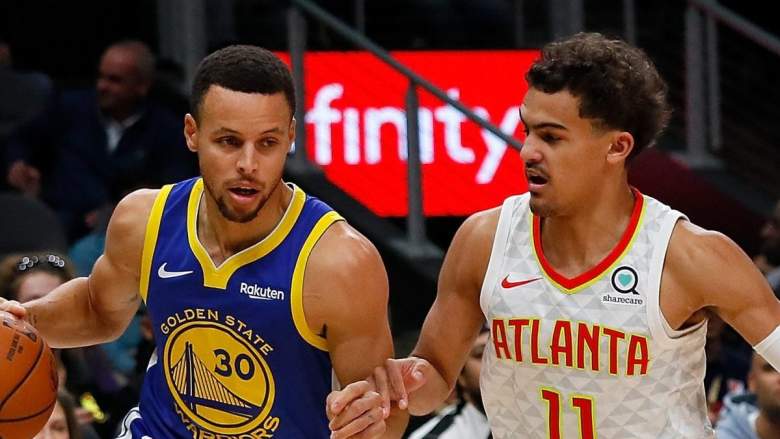 Golden State Warriors guard Stephen Curry drives past Trae Young of the Atlanta Hawks.