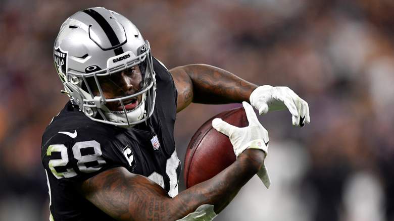 Oakland Raiders running back Josh Jacobs (28) warms up before an NFL  football game against the …