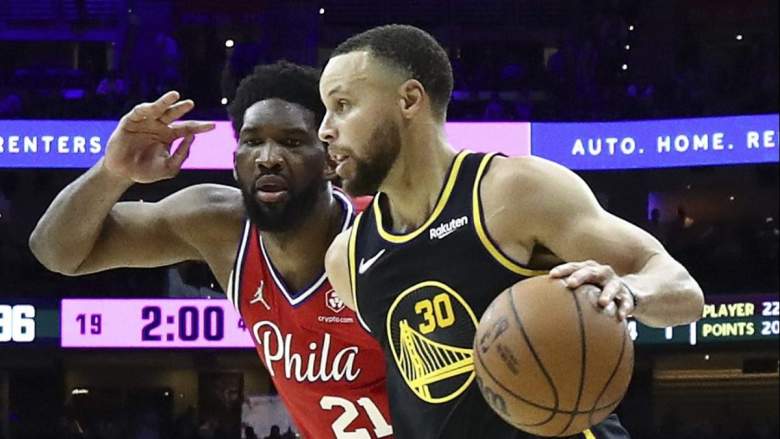 Philadelphia 76ers star Joel Embiid guards Golden State Warriors guard Stephen Curry.