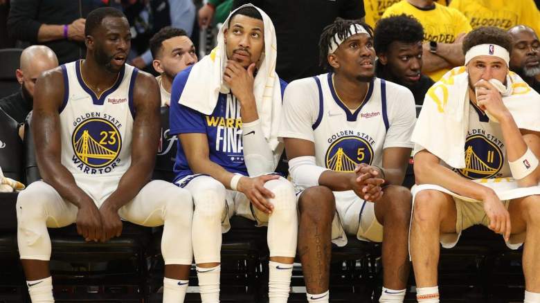 Draymond Green sits alongside his Golden State Warriors teammates.