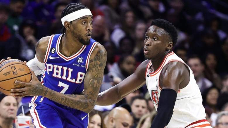 Philadelphia 76ers wing Jalen McDaniels is guarded by Victor Oladipo of the Miami Heat.