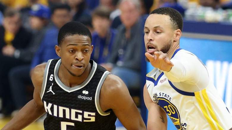 Sacramento Kings guard De'Aaron Fox drives past Stephen Curry of the Golden State Warriors.