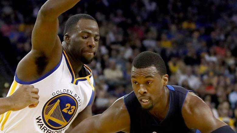 Golden State Warriors star Draymond Green defends Harrison Barnes of the Sacramento Kings.