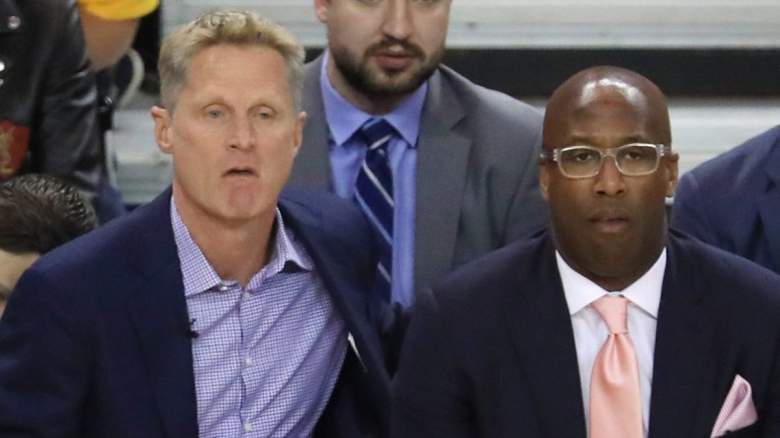Golden State Warriors head coach Steve Kerr sits alongside Mike Brown.