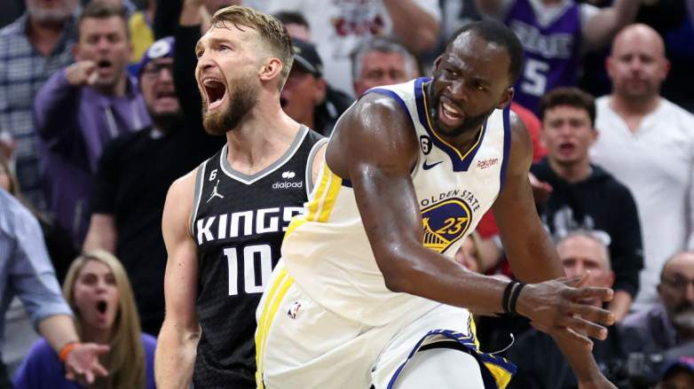 Domantas Sabonis of the Sacramento Kings and Draymond Green of the Golden State Warriors.