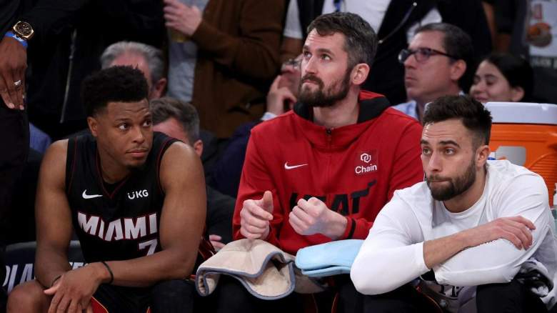 Kyle Lowry, Kevin Love, and Max Strus sit on the Miami Heat bench.