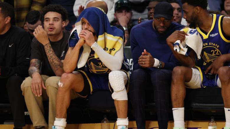 Stephen Curry sits on the Golden State Warriors' bench.