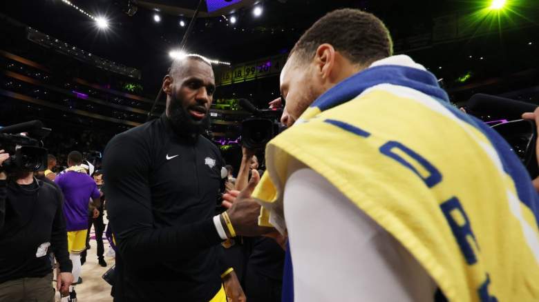 Los Angeles Lakers star LeBron James shakes hands with Stephen Curry of the Golden State Warriors.