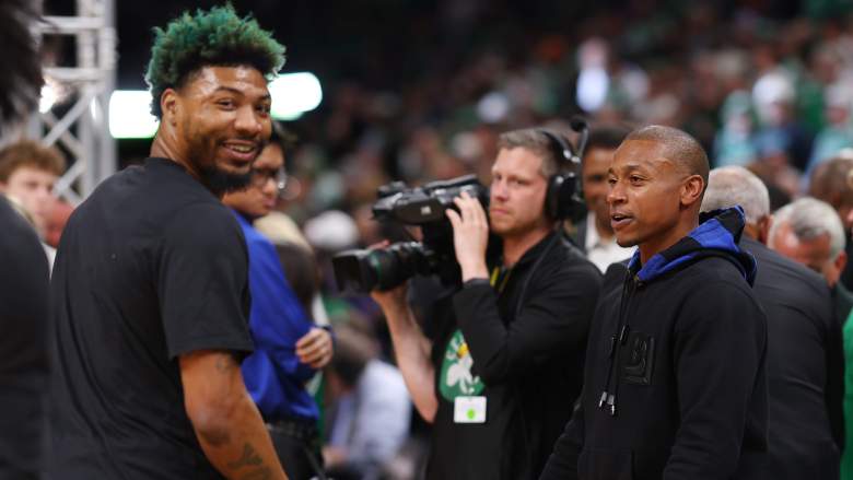 Isaiah Thomas, fomer Celtics star, talks with Marcus Smart during the Eastern Conference finals.