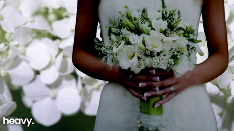 A bride holding flowers.