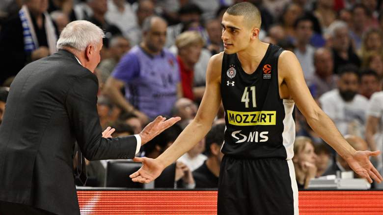 Celtics prospect Yam Madar (right) talks with Partizan coach Zeljko Obradovic.