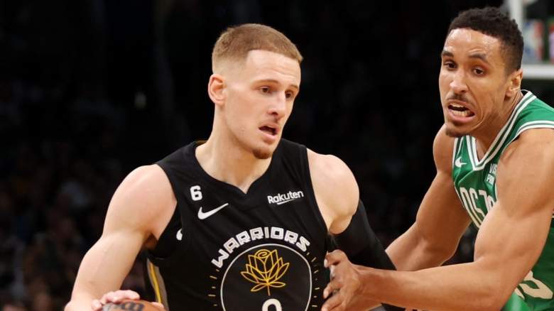 Golden State Warriors guard Donte DiVincenzo is defender by Malcolm Brogdon of the Boston Celtics.