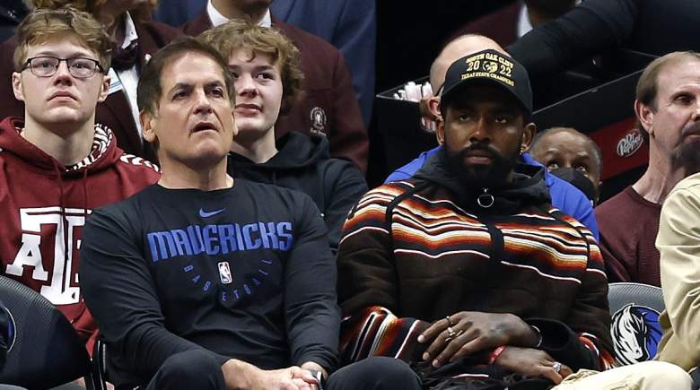 Dallas Mavericks owner Mark Cuban sits alongside Kyrie Irving.