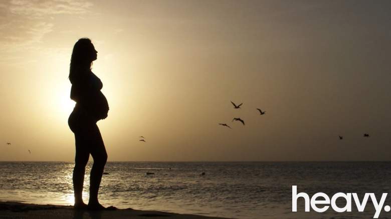 A pregnant woman on a beach.