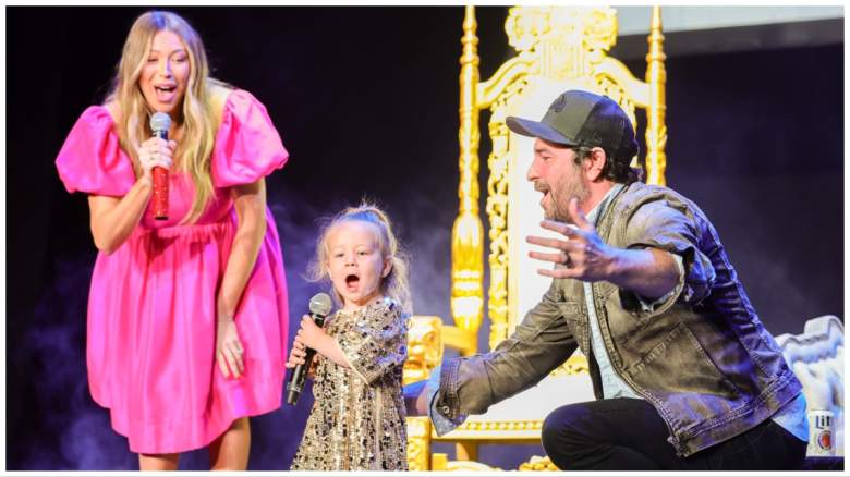 Stassi Schroeder, Beau Clark, and Hartford Clark on stage in June 2023.