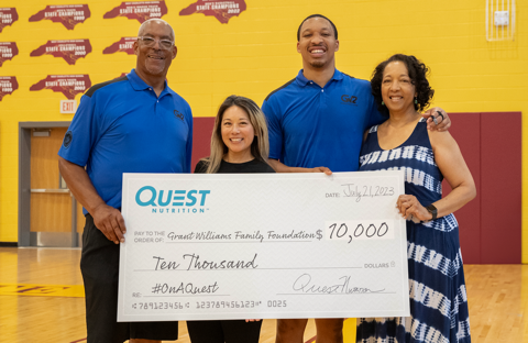 Grant Williams’ parents, Gilbert Williams and Teresa Johnson, along with Quest Nutrition spokesperson Grace Niu join Grant Williams on July 21 to accept Quest Nutrition’s $10,000 donation during the Inaugural Youth Basketball Camp at West Charlotte High School in Charlotte, North Carolina on July 21, 2023. (Photo: Courtesy of Quest Nutrition/Derek McCoy) 