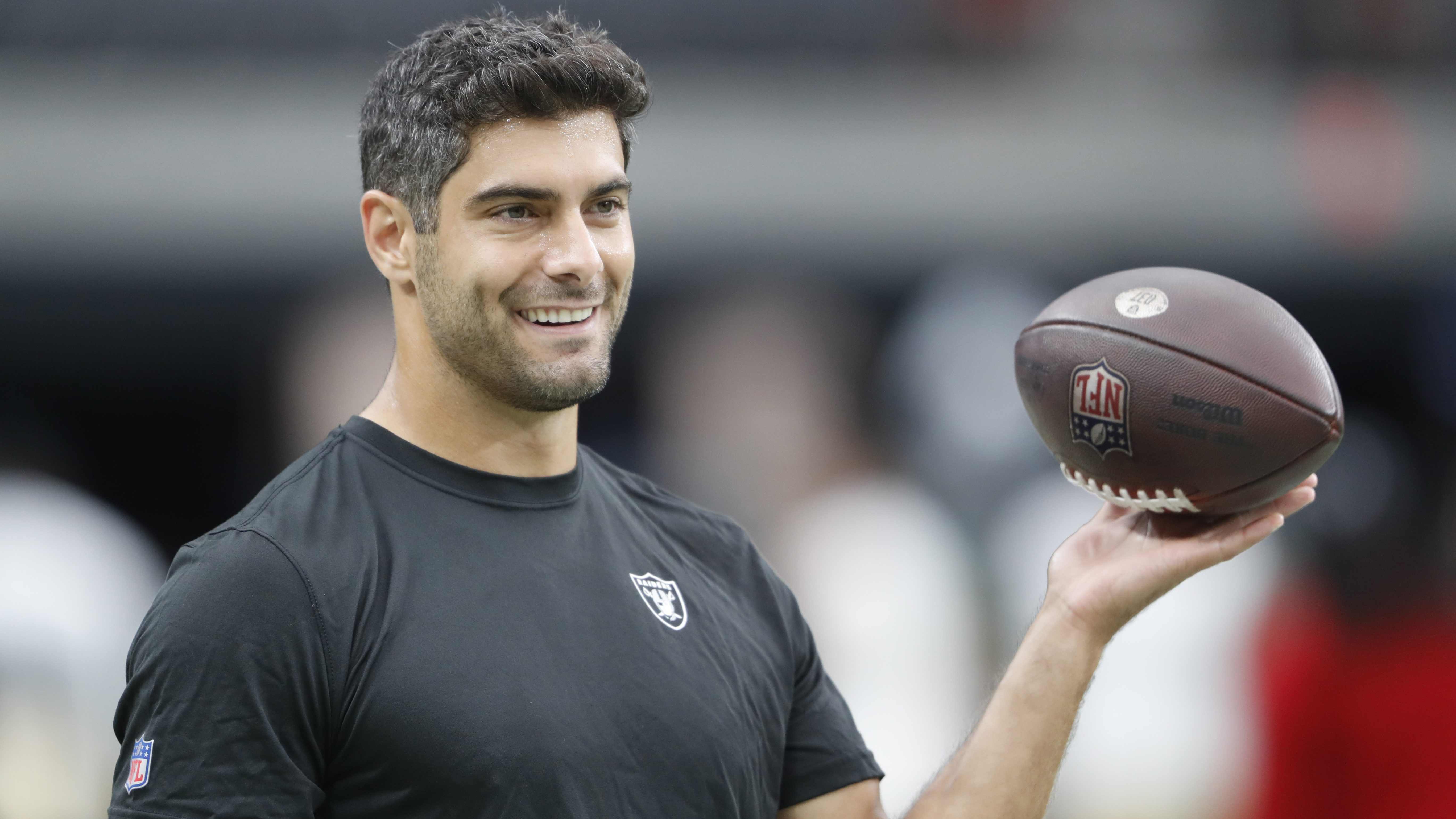 Las Vegas Raiders quarterback Jimmy Garoppolo (10) wipes away