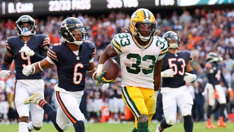 Aaron Jones of the Packers clutches his hamstring on his way to his second touchdown of Week 1.